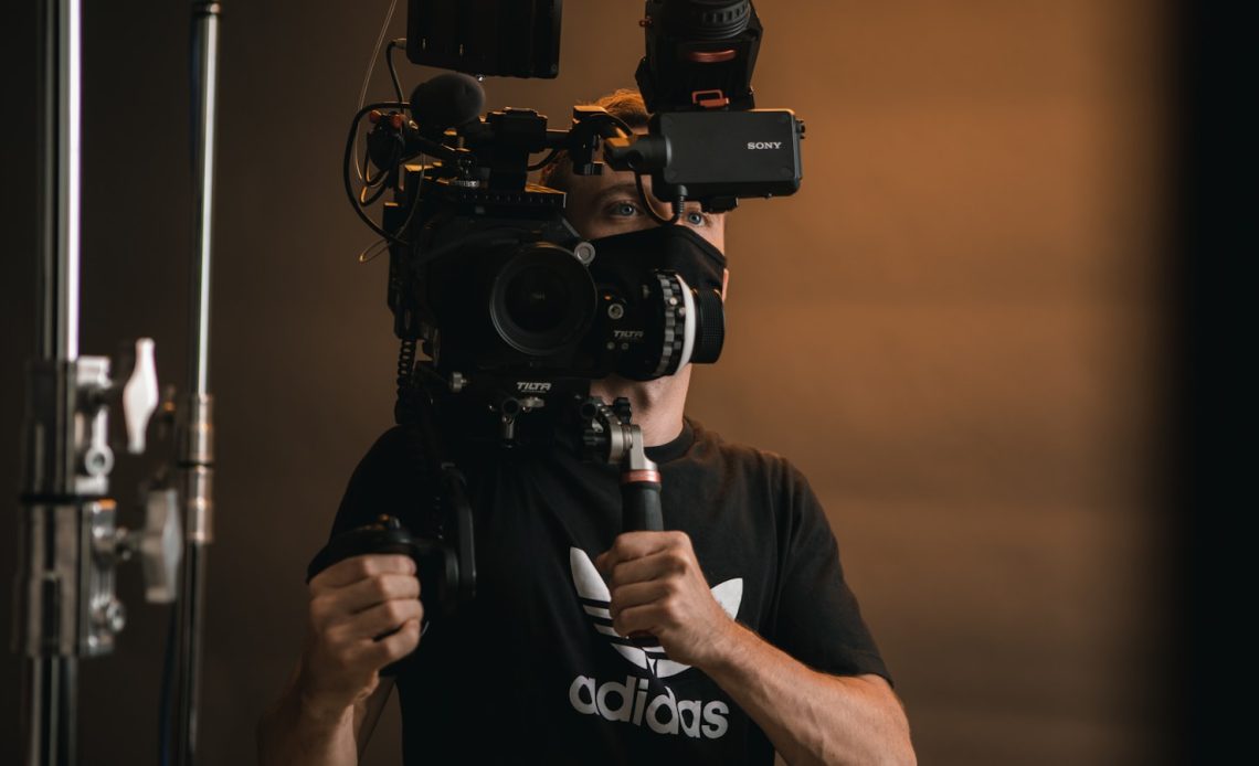 a man holding a camera in front of his face