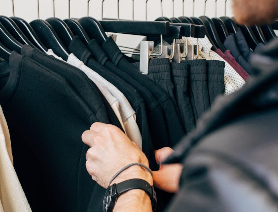 man holding black shirt