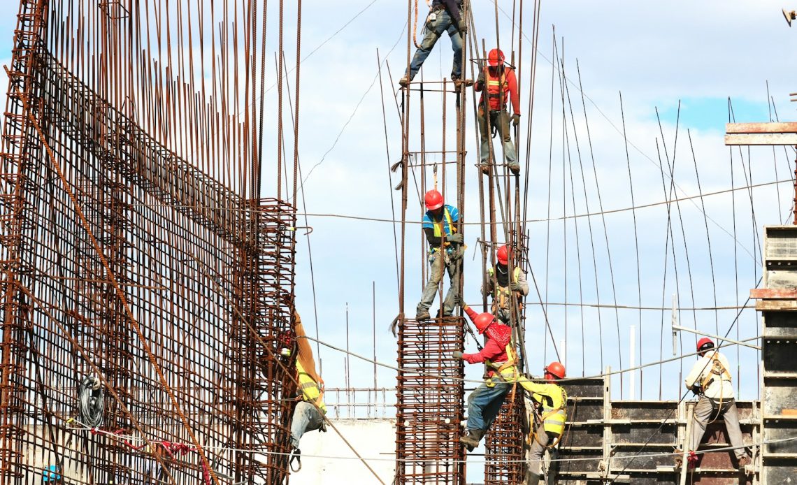 people working on building during daytime