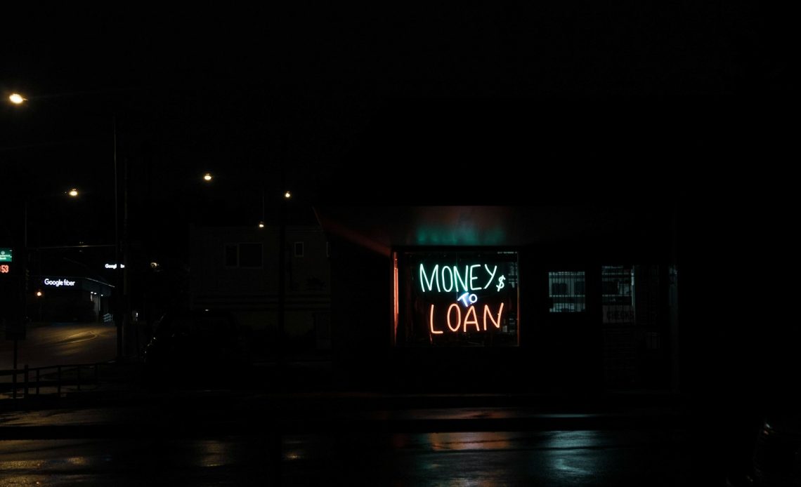 a neon sign is lit up in the dark