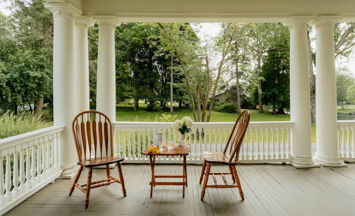 Two chairs and a table on a porch