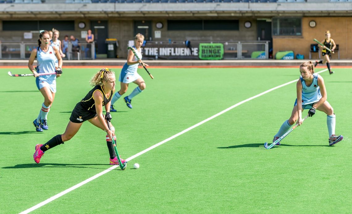 woman wearing black jersey playing on field